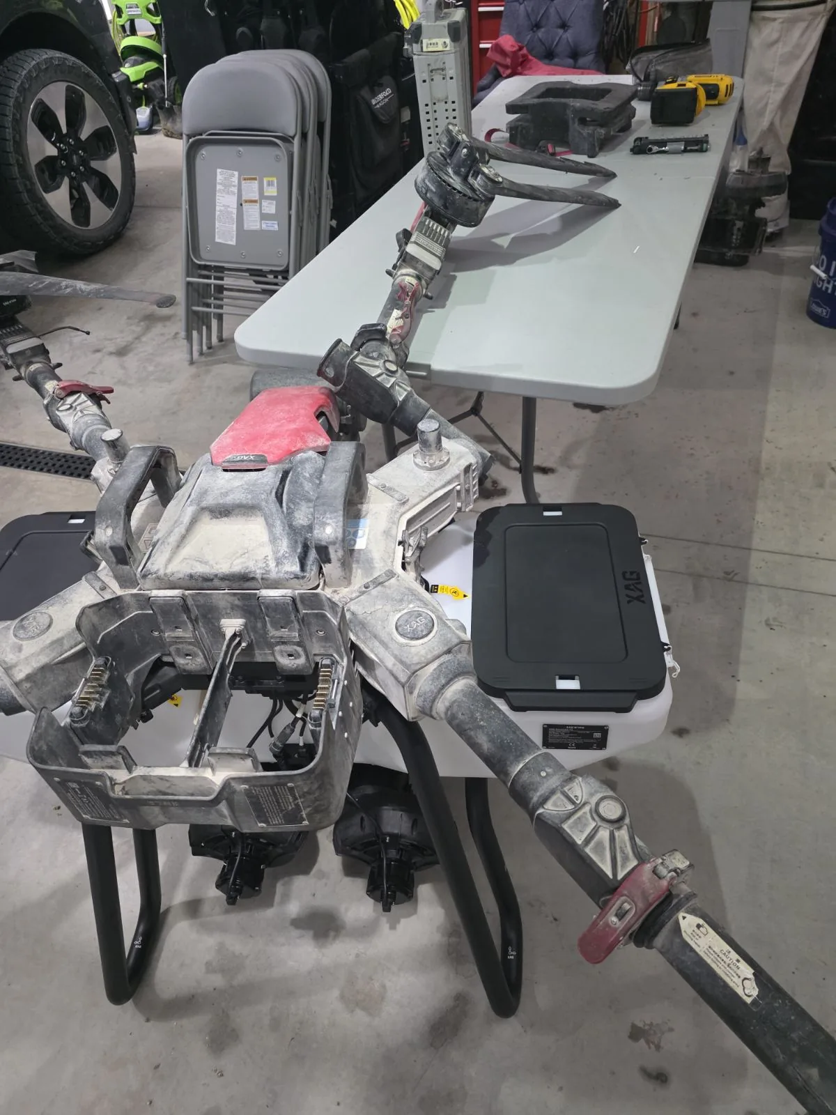 A spray drone partly disassembled on a bench during a repair.
