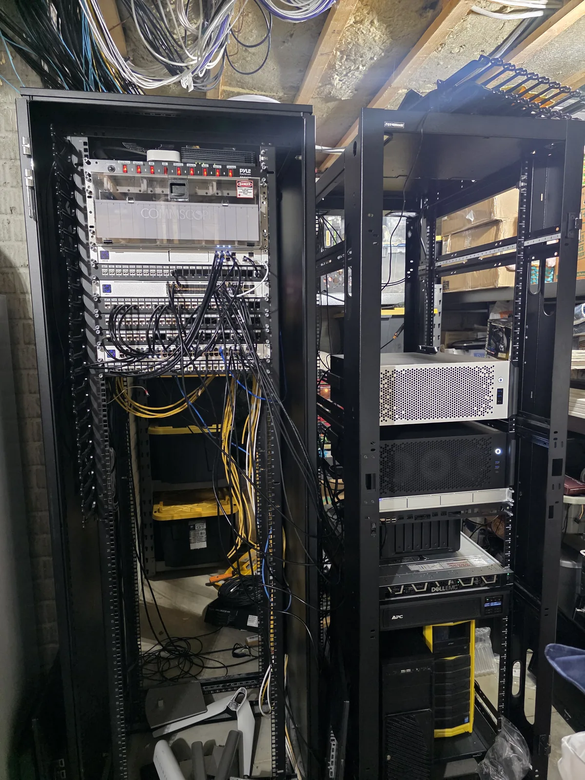 A network rack part-way through a build, with cabling being run and dressed.